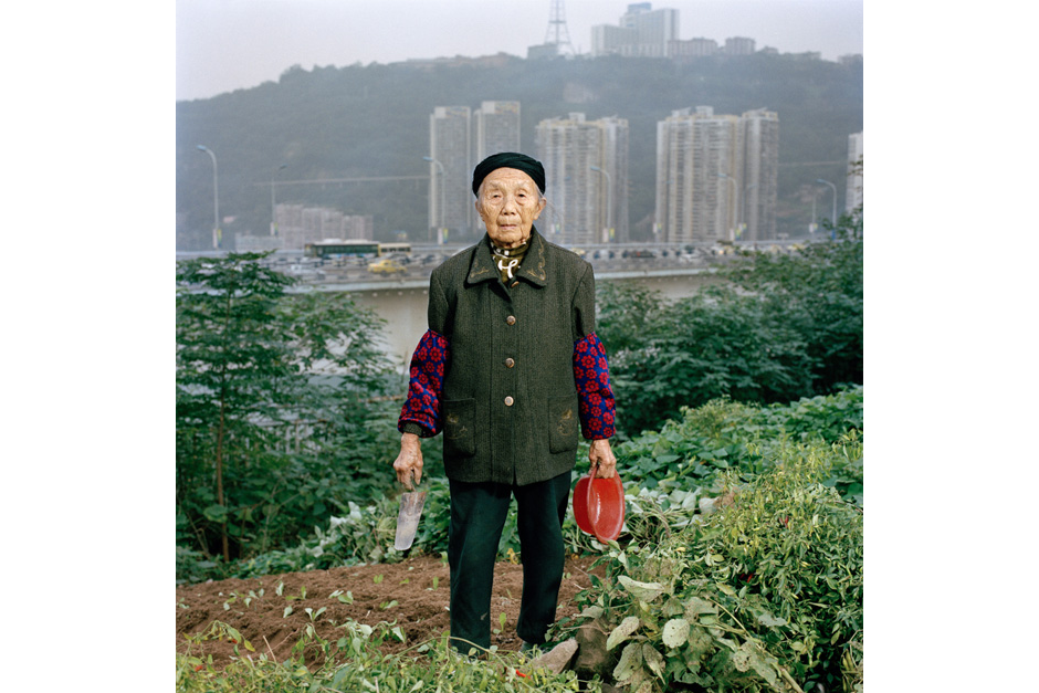 Zhong Baixin, eighty-seven, is cultivating a square meter of lettuce for her own table. She has lived all her life in Chongqing and now lives in what remains of a farming village stuck between a construction site and a road.