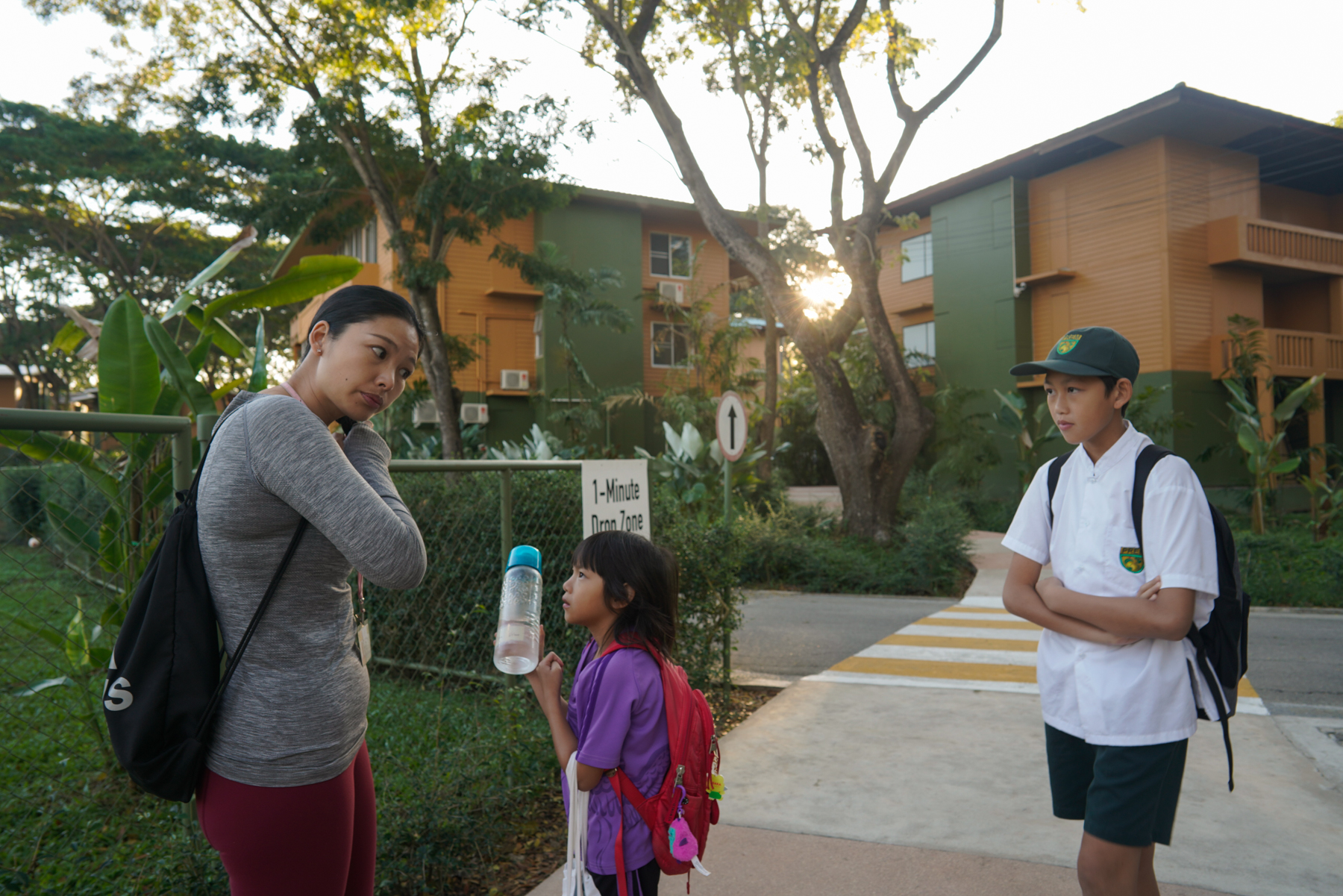 Ding Dian, from Huizhou, Guangdong province, sends her two children off to school, January 16, 2019. Both of them attend Prem Tinsulanonda International School, whose campus features a golf center and a tennis center. 